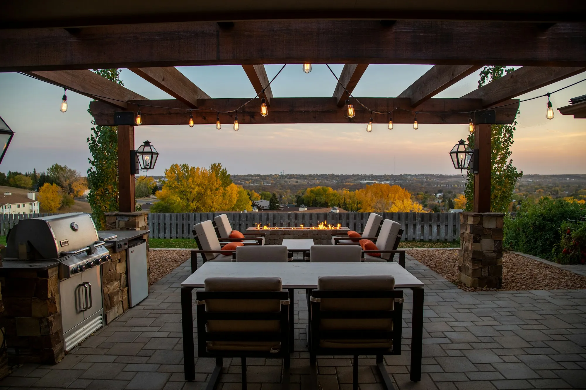 Covered outdoor kitchen and dining area on a paved patio